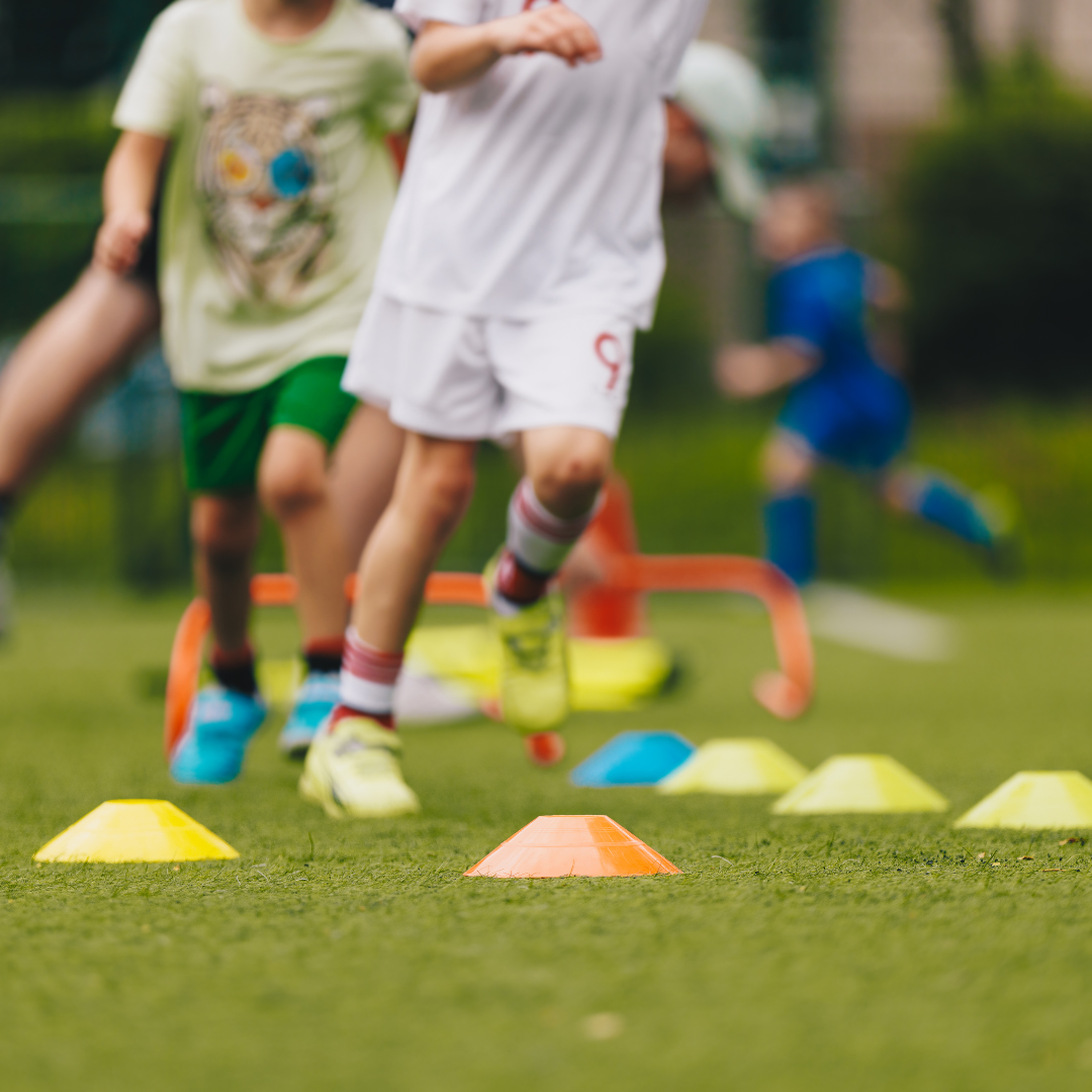 Child running through cones. Physical Education class.