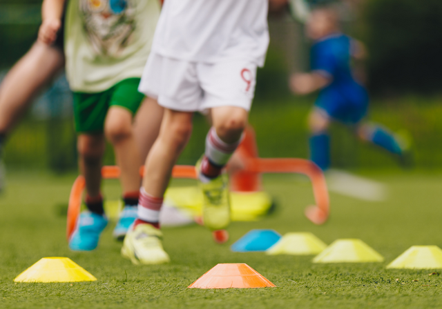 Child running through cones. Physical Education class. 