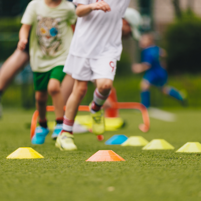 Child running through cones. Physical Education class.